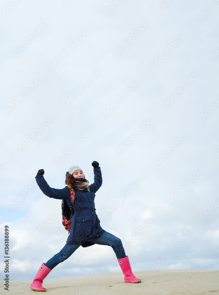 energetic funny young woman enjoying life and posing on on winter beach. energy, strength, power, success concept energetic funny young woman enjoying life and posing on on winter beach. energy, strength, power, success concept