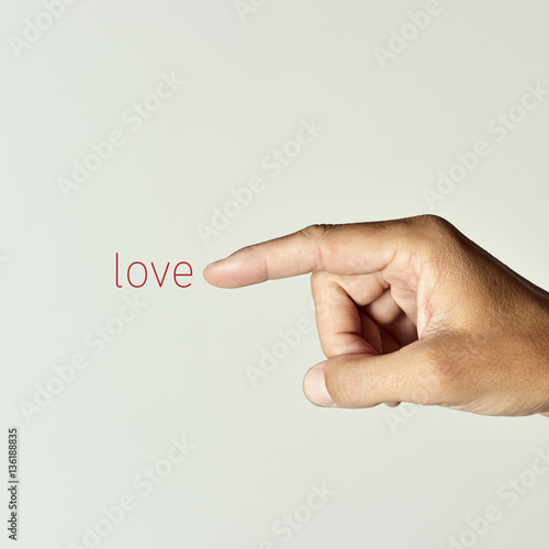 man pointing the word love