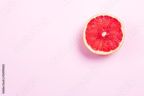 Half grapefruit citrus fruit on pink background