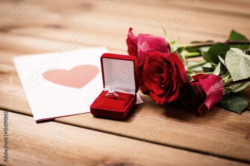 фотографія close up of diamond ring, roses and greeting card