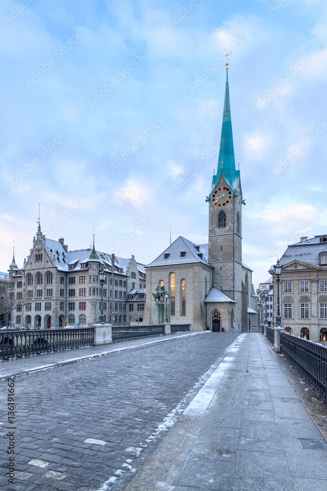 Winter landscape of Zurich. Waldmann monument and Munsterbrucke bridge, Switzerland