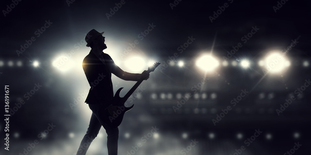 Elegant guitarist silhouette . Mixed media