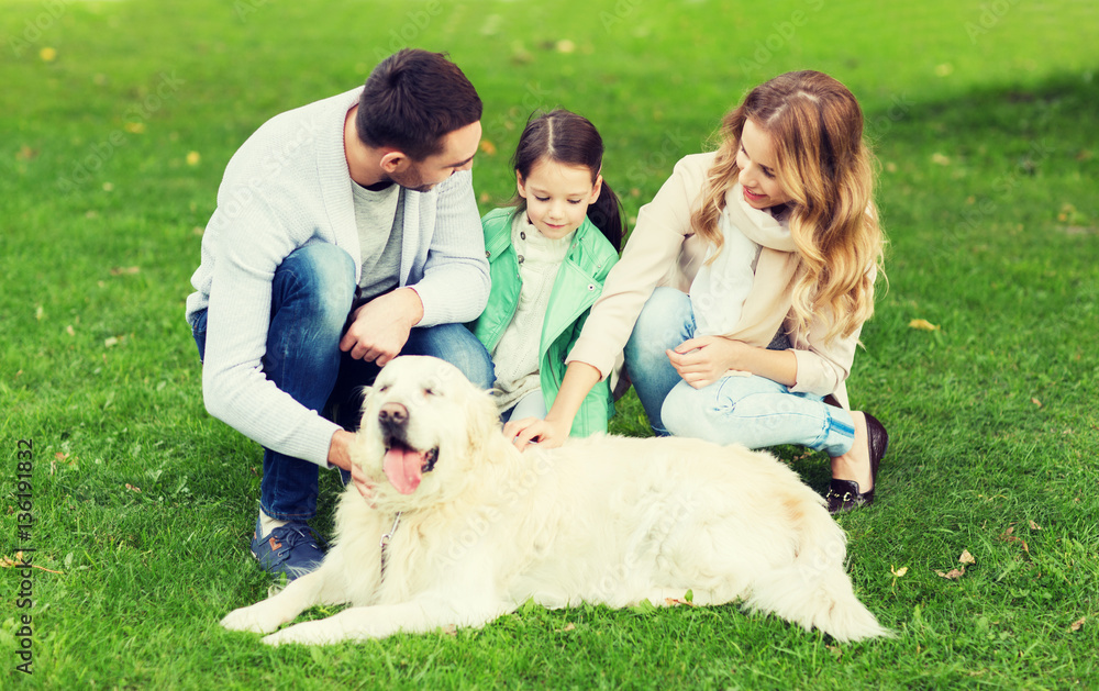 happy family with labrador retriever dog in park