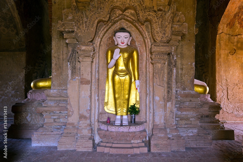 Naklejka premium Standing golden Buddha statue in Myanmar