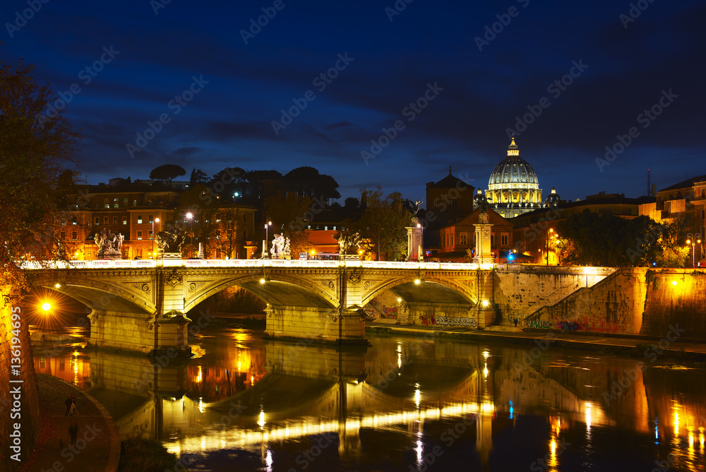 Night view of Ponte Vittorio Emanuele II bridge across Tiber river, Rome, Italy