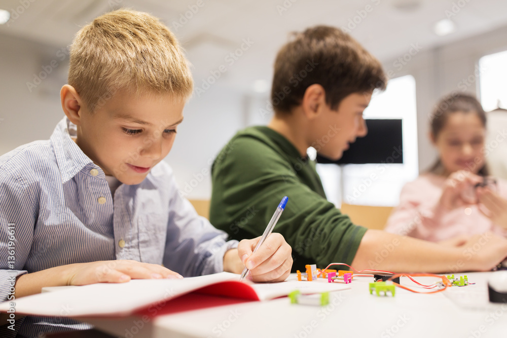 happy children building robots at robotics school happy children building robots at robotics school