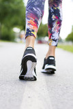 Woman with an athletic pair of shoes going for a jog or run