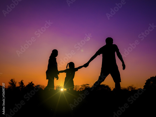 silhouette father, mother and daughter