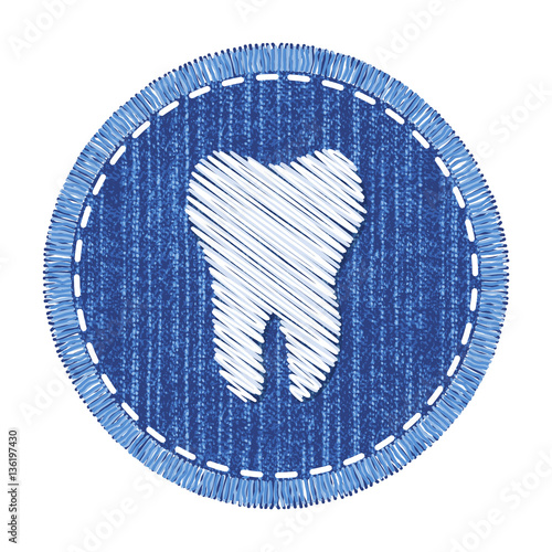 Blue round denim patch with white tooth embroidery, stitch and fringe. Jeans fabric with symbol of dental care. Element for desirn at International Dentist Day.