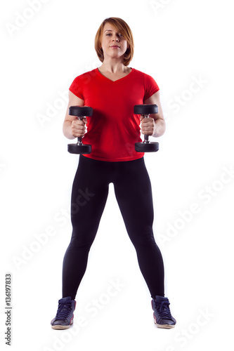 Beautiful fit woman making exercises with dumbbells