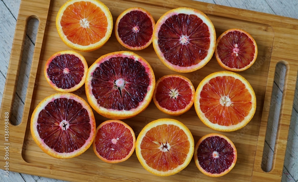 Tray of ruby red blood oranges cut in half Tray of ruby red blood oranges cut in half