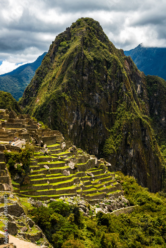 View of the Lost Incan City of Machu Picchu near Cusco, Peru. Machu Picchu is a Peruvian Historical Sanctuary. People can be seen on foreground.