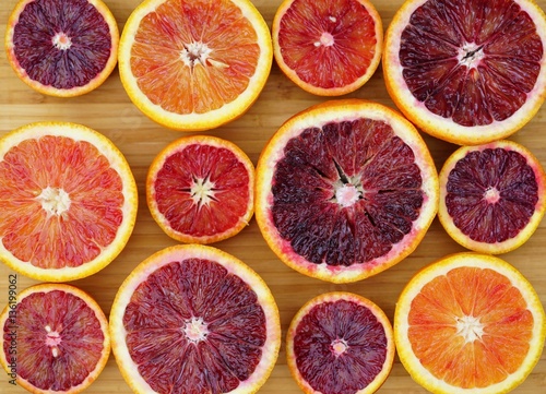 Tray of ruby red blood oranges cut in half 