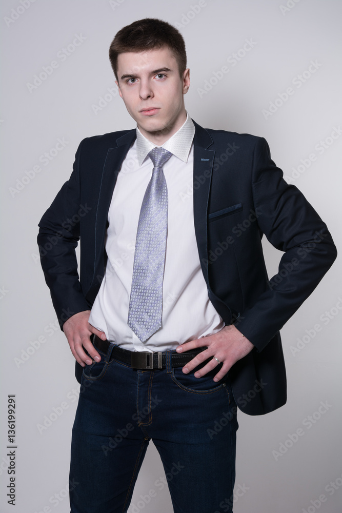 Fototapeta premium Portrait of serious young businessman hands on his belt