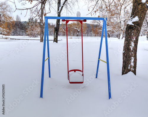 Children's playground covered with snow in winter photo