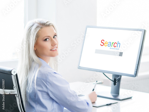 Young, attractive and confident woman working in office. Retouch