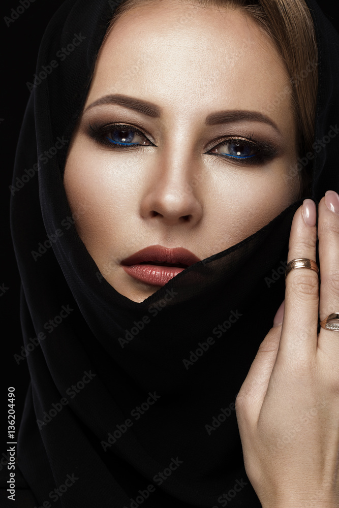 Beautiful girl in the Arab scarf with oriental make-up. Beauty face. Photos shot in the studio. Beautiful girl in the Arab scarf with oriental make-up. Beauty face. Photos shot in the studio.