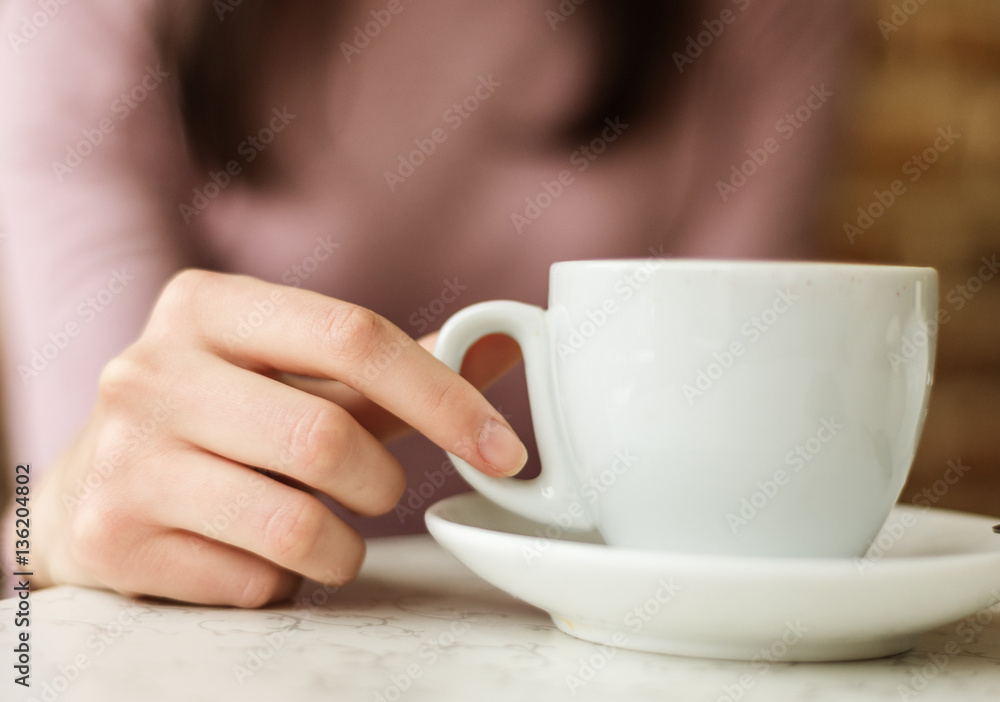 woman drinking coffee sitting by the window in the house. woman drinking coffee sitting by the window in the house.