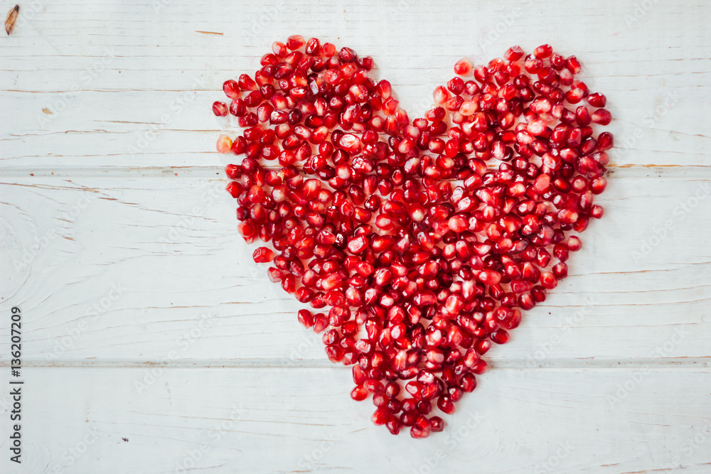 Red heart made from pomegranate seeds - valentines day symbol Red heart made from pomegranate seeds - valentines day symbol