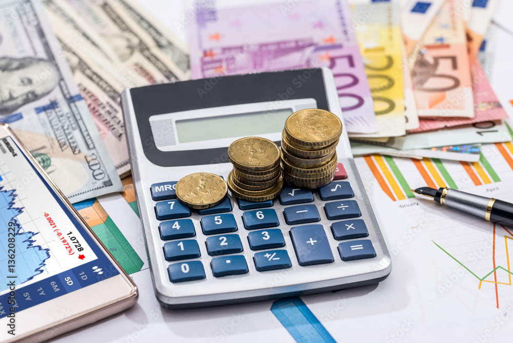 euros and dollar bills woth calculator and business graph. euros and dollar bills woth calculator and business graph.