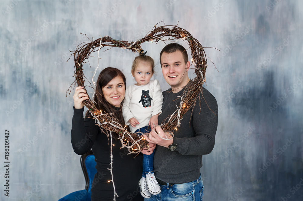 Portrait of a happy family in frame from heart. Love holiday. St. Valentine's Day.