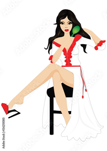 Beautiful girl combs her hair after a bath, sitting in a chair in a bathrobe