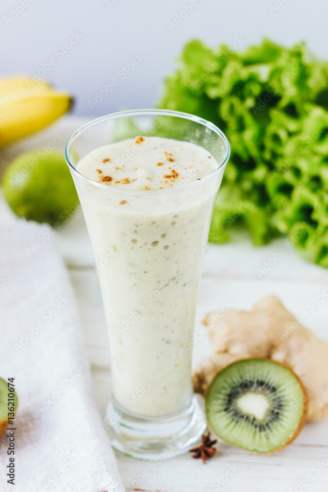Fresh smothie - vegan drink with banana, salad leaves, ginger and kiwi. Fresh smothie - vegan drink with banana, salad leaves, ginger and kiwi.
