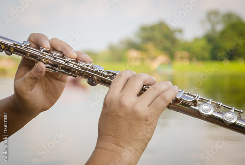 Hands of a woman playing a flute