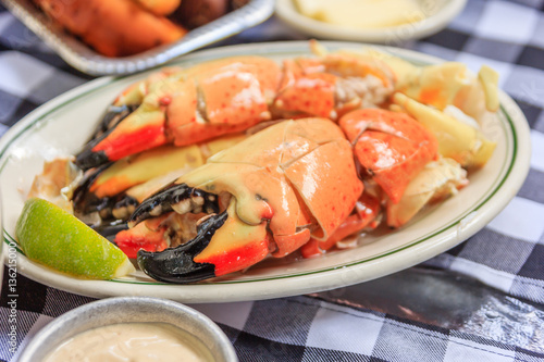 Stone crab claws with lemon butter and mustard on a plate as photographed in south beach miami florida