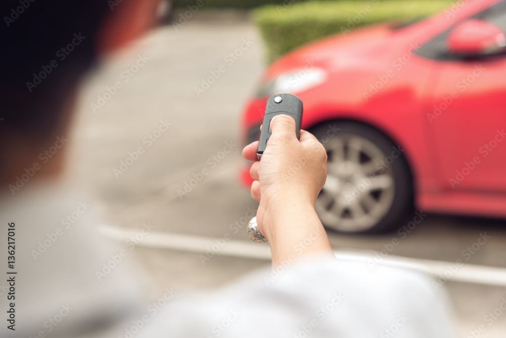 Men’s hand open the car with remote control key