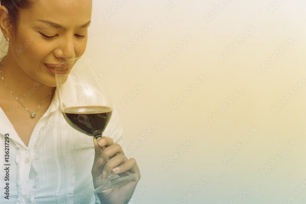 Beautiful business woman holding red wine glass for celebrate Beautiful business woman holding red wine glass for celebrate
