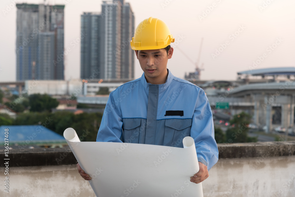 Foreman looking at blueprint at a construction site Foreman looking at blueprint at a construction site