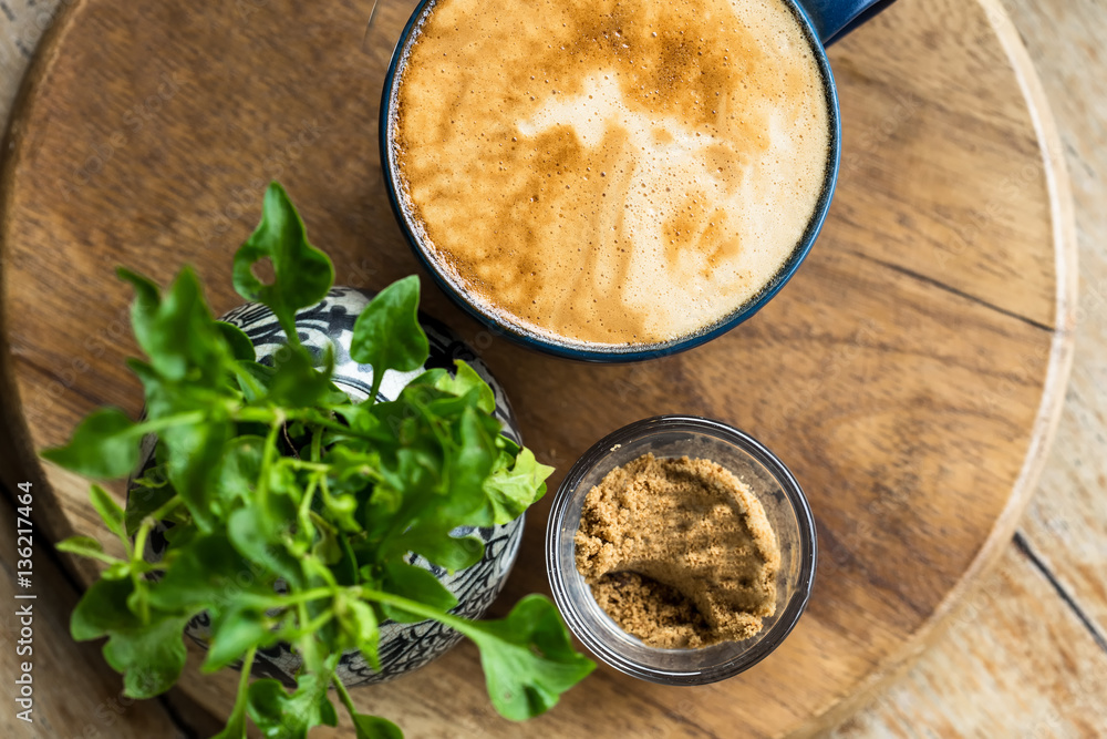 Hand with a cup of coffee Hot cappuccino coffee in afternoon lig Hand with a cup of coffee Hot cappuccino coffee in afternoon lig