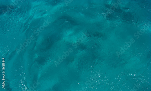 The texture of the seafloor through the clear water