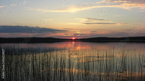 Karelia sunset on the lake in the woods