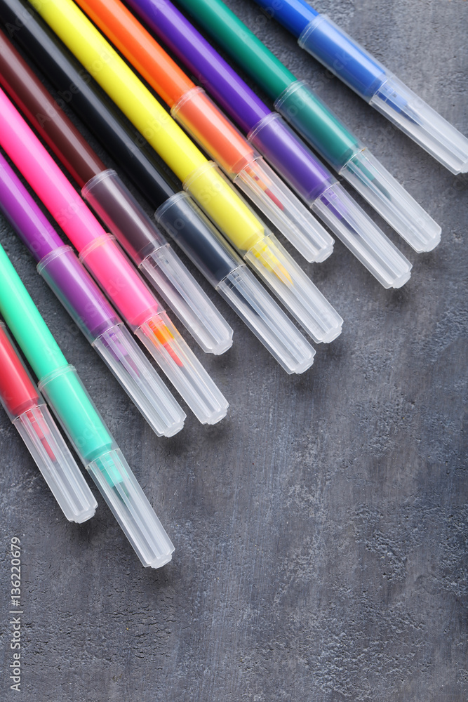 Fototapeta premium Felt-tip pens on a grey wooden table