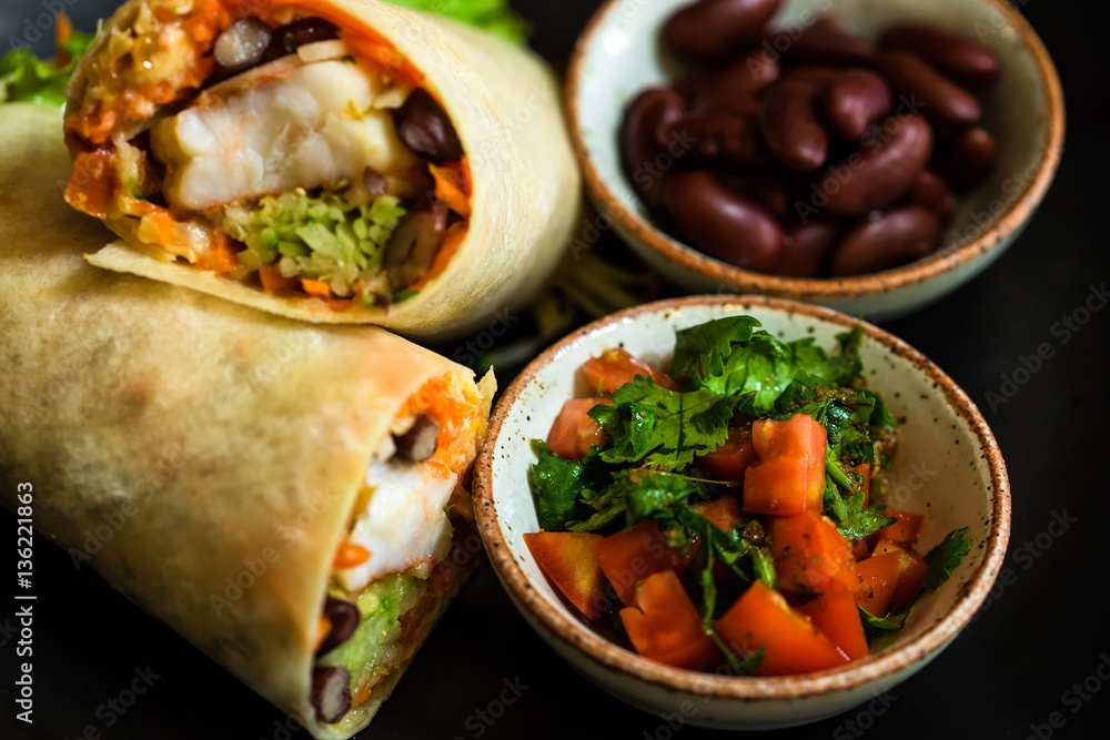 High Angle Still Life of Trio of Tex Mex Fajita Wraps Wrapped in High Angle Still Life of Trio of Tex Mex Fajita Wraps Wrapped in