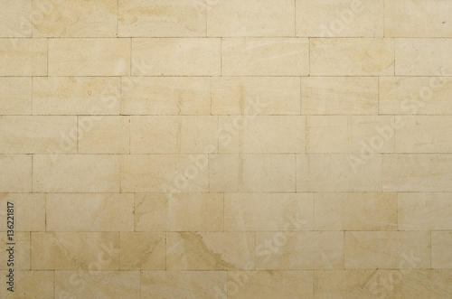 Background of gray-yellow porous sandstone blocks photo