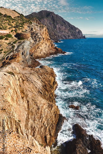 Rocky coastline and part of Battery of Cabo Negrete. Spain photo