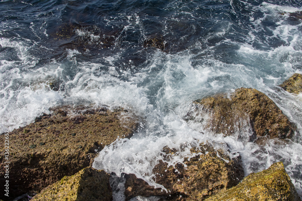 Waves breaking on the rocks.