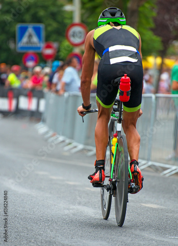 Unrecognizable professional cyclist during the bicycle competition. Back view.