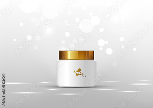 Cosmetic bottle for cream. White jar and gold glossy lid on the light gray background for ads.