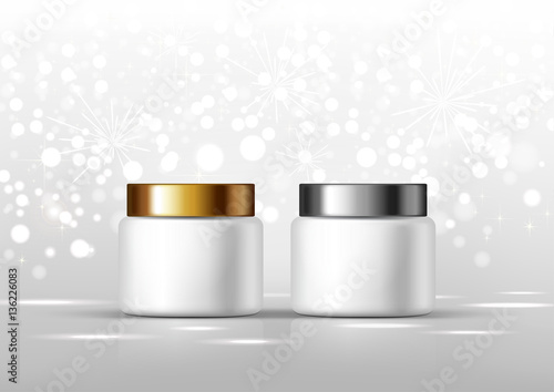 Two cosmetic bottles for cream. White jar and gold, silver glossy lid on the gray background for ads.
