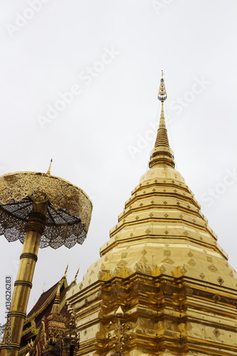 Golden pagoda in the temple on background sky. © yothinsanchai777