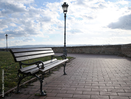 The bench next to the wall with unreachable views of the Danube and Novi Sad from the Petrovaradin Fortress, Serbia © mr2853