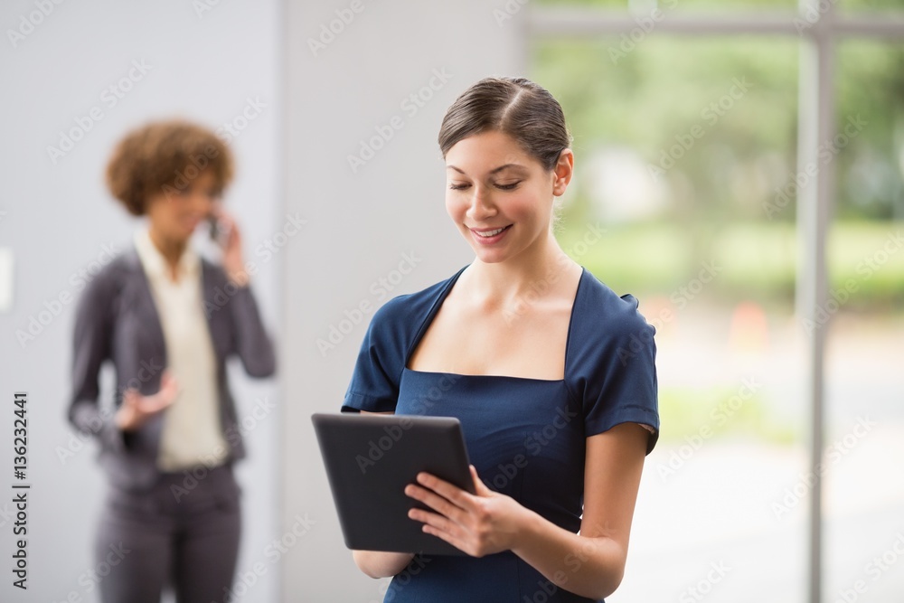Beautiful business executive using digital tablet Beautiful business executive using digital tablet