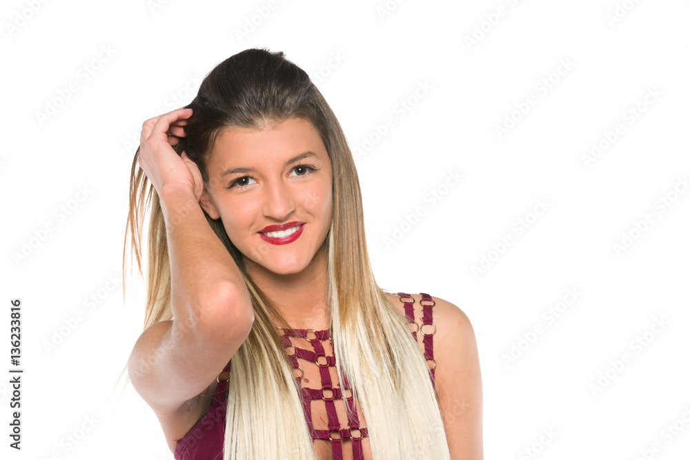 Young girl with long hair posing in studio,looking at camera Young girl with long hair posing in studio,looking at camera