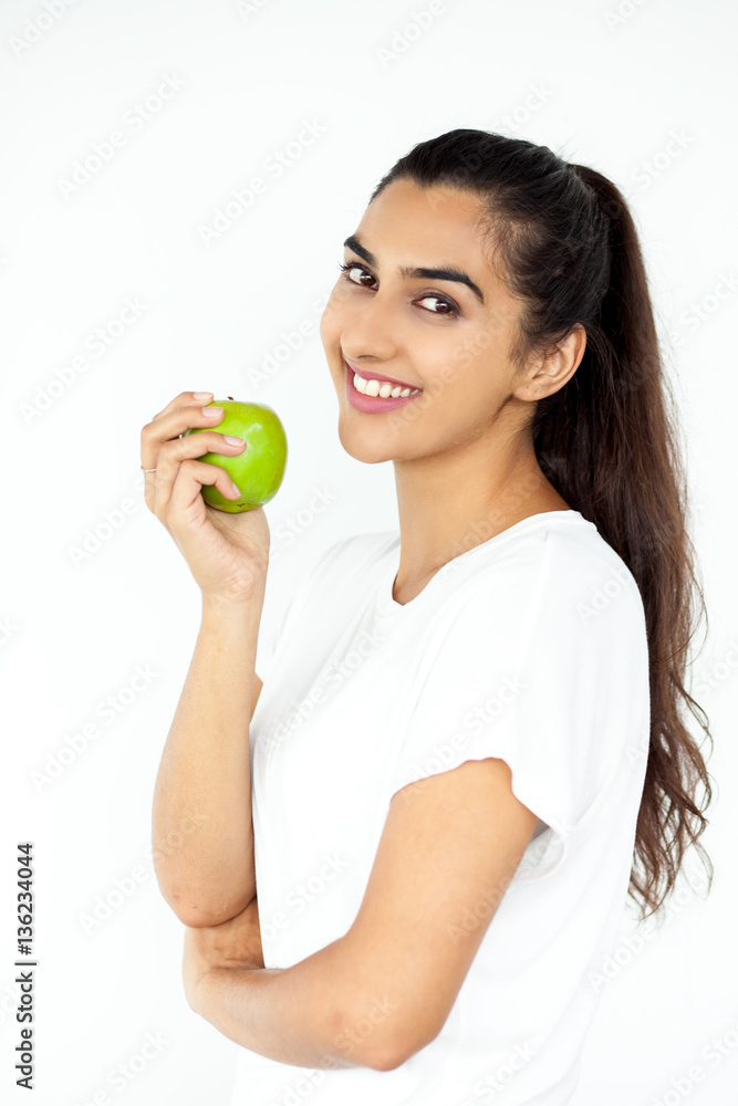 Energetic sportswoman holding apple Energetic sportswoman holding apple