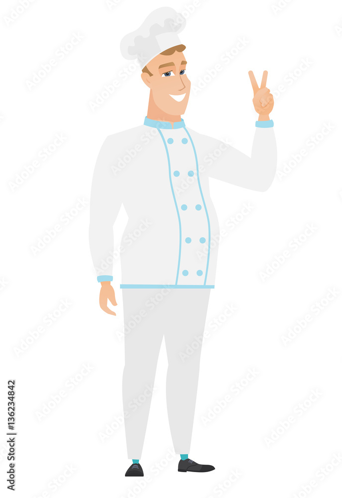 Caucasian chef cook showing the victory gesture. Caucasian chef cook showing the victory gesture.
