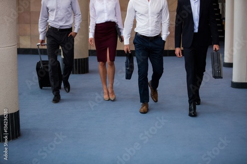 Business executives walking in a conference center lobby
